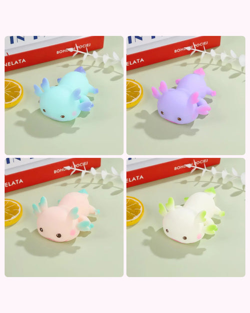 All four Axolotl Squishy colours side by side — blue, purple, pink and white — shown in a four-panel grid.
