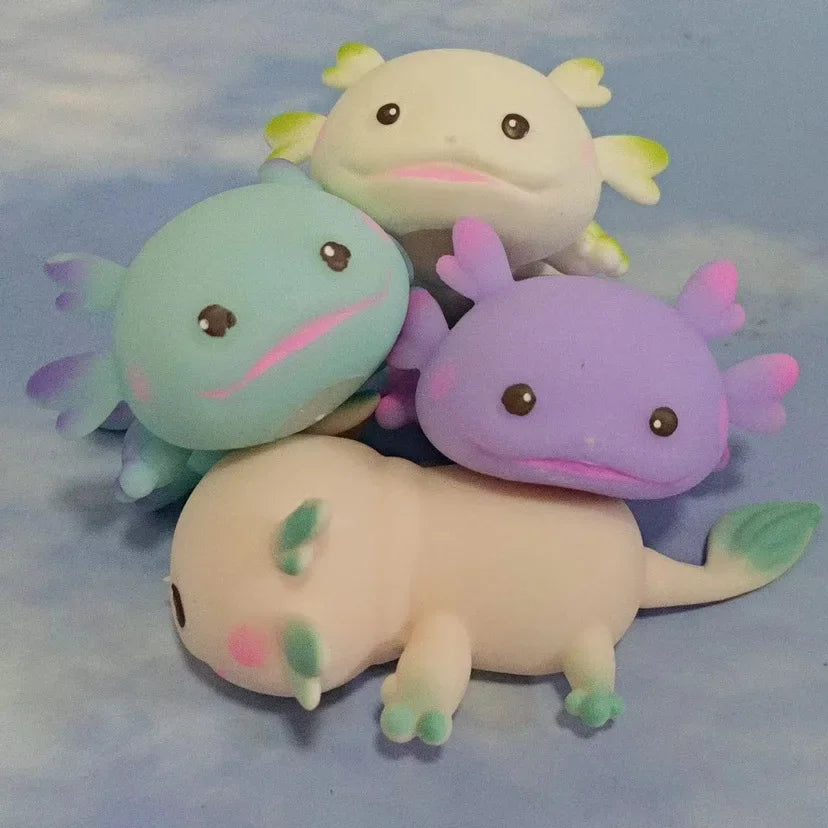 Four axolotl squishies together in blue, purple, pink and white, showing all the available colours.