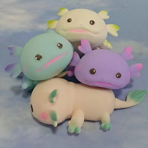 Four axolotl squishies together in blue, purple, pink and white, showing all the available colours.