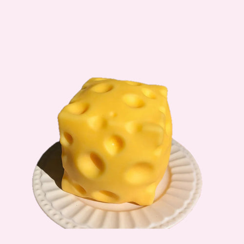 Big Cheese squishy, a large yellow slow rise cheese block sensory toy, on a pink background - Trendy Toyz AU
