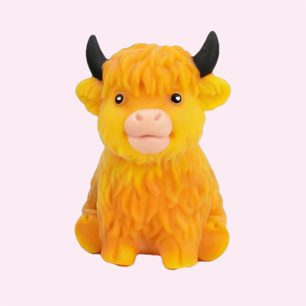 Highland Cow Squishy in orange, a fluffy slow rise sensory toy, on a pink background - Trendy Toyz AU