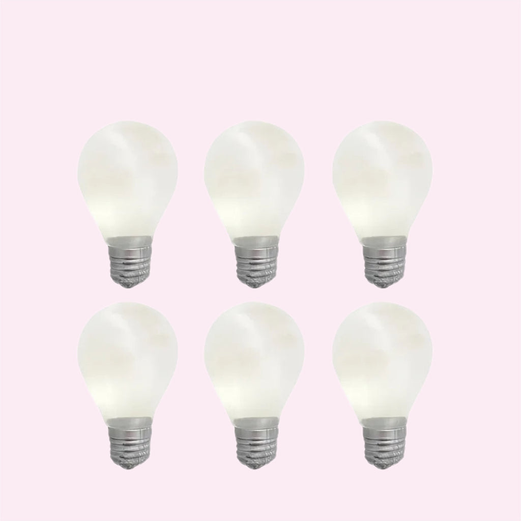 Six glow in the dark lightbulb squishies arranged on a pink background - Trendy Toyz AU