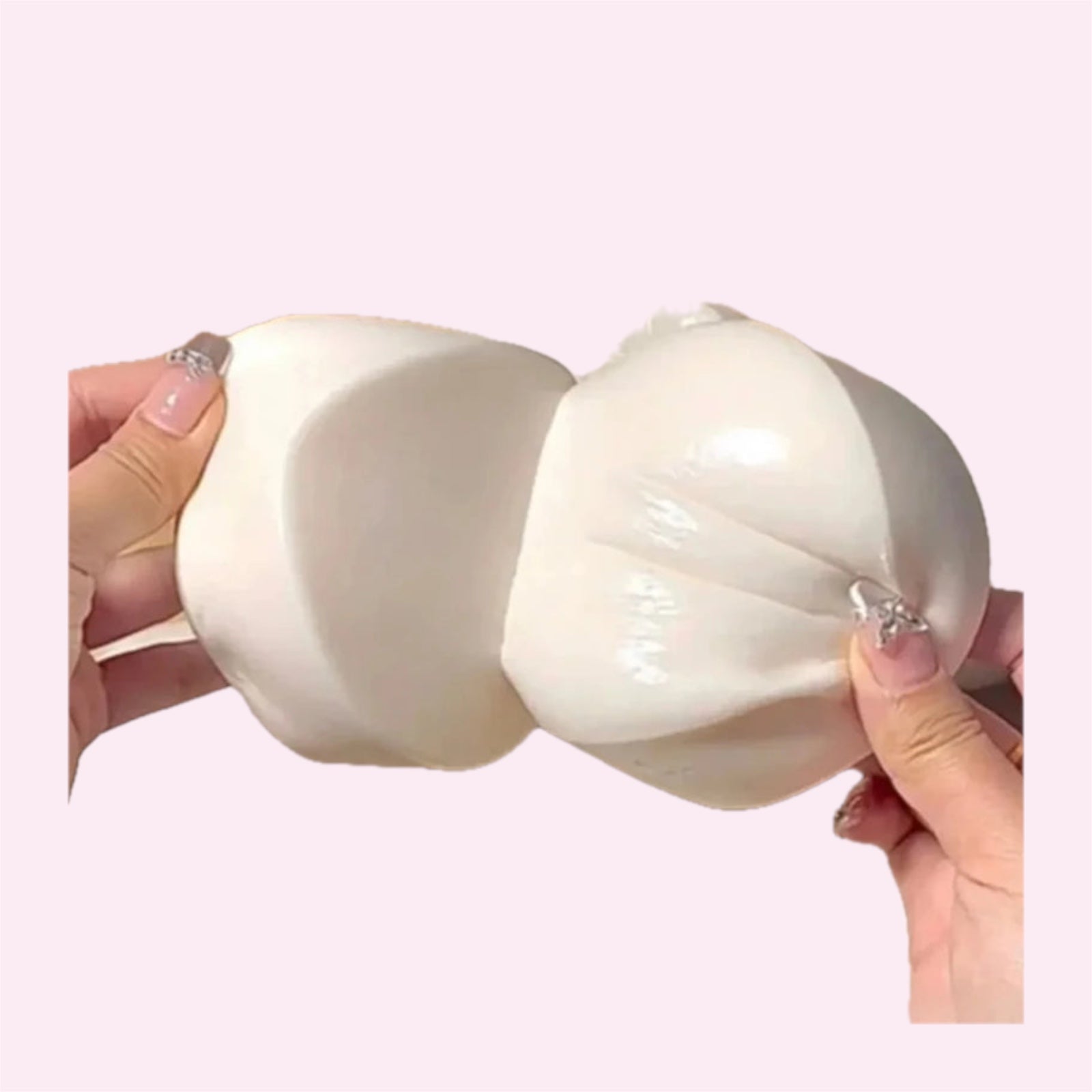 Large slow rise yoghurt bun squishy held in one hand on a pink background - Trendy Toyz AU